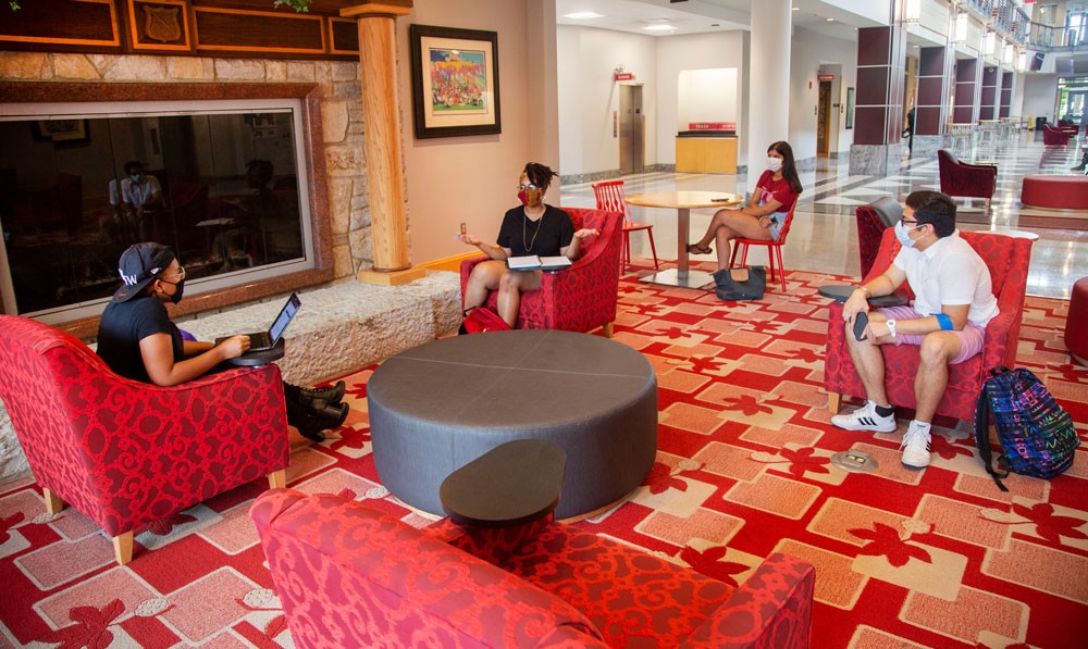 Image of four students sitting, physically distanced, in the Ohio Union